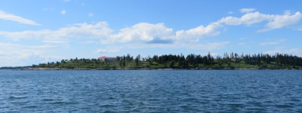 View of Hope Island with large house and its coastline.